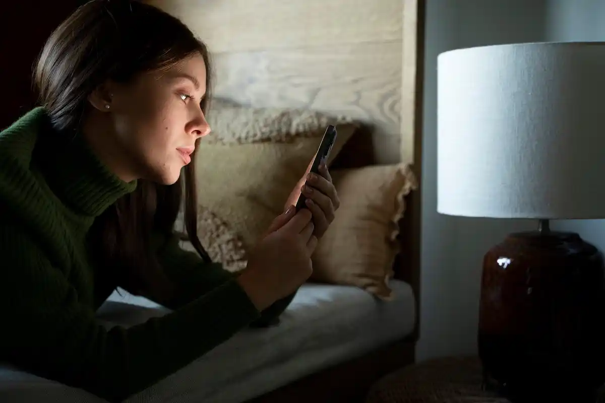 phone charging on bedside table at night