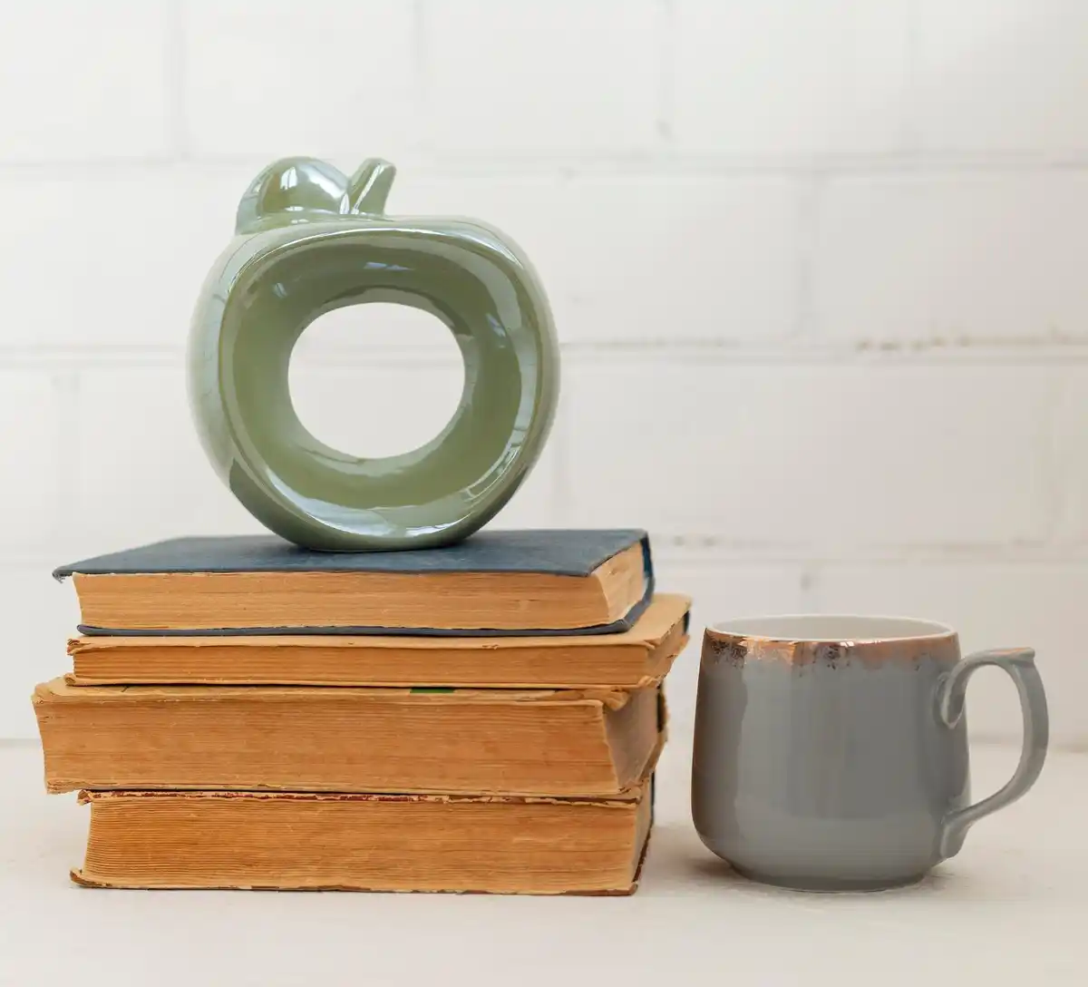 stack of old Dutch books on a wooden table, cozy home interior