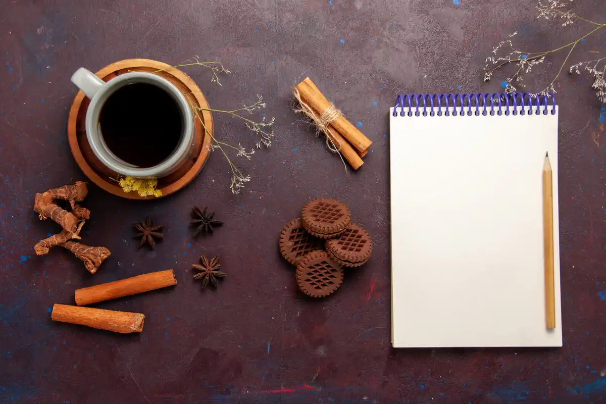 vintage notebooks on desk with coffee