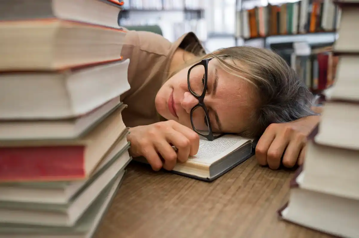 burned out student studying in dutch library