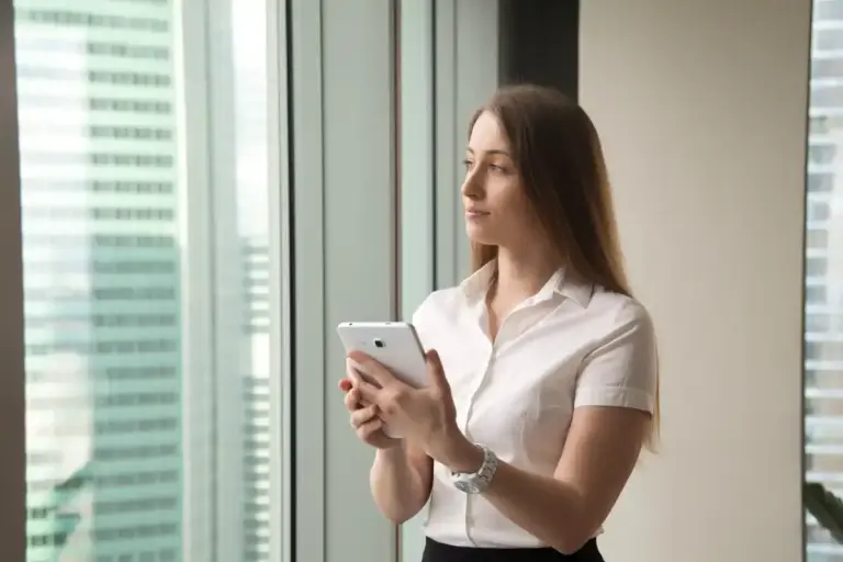 Dutch office employee checking phone secretly