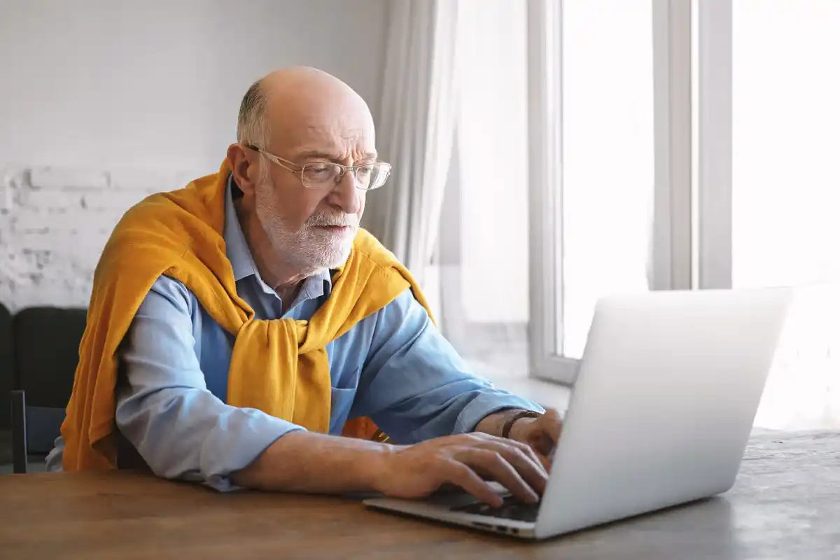 elderly man focus working at home laptop netherlands
