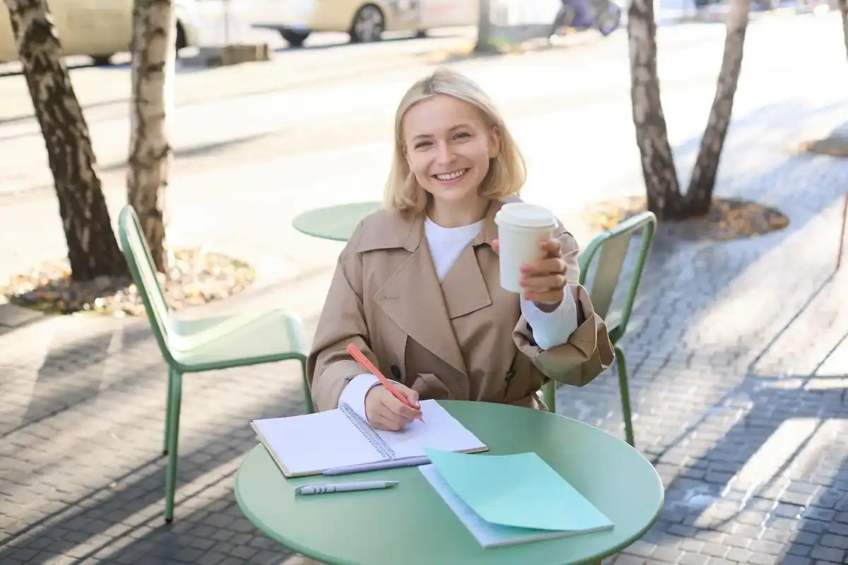 notebook planning pen coffee desk senior woman netherlands