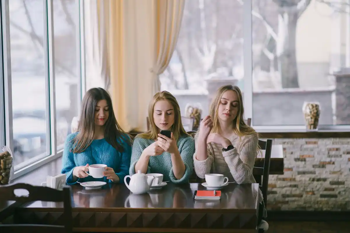 group of adults talking in Dutch café without phones