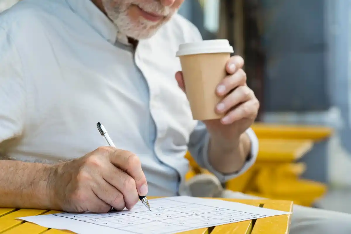 dutch person taking handwritten notes in modern cafe
