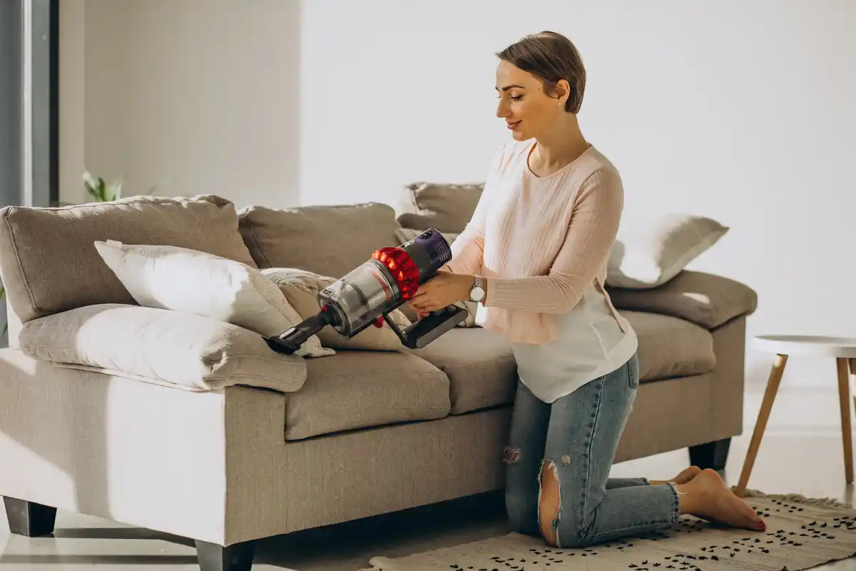 Dutch woman cleaning home with water filter vacuum cleaner