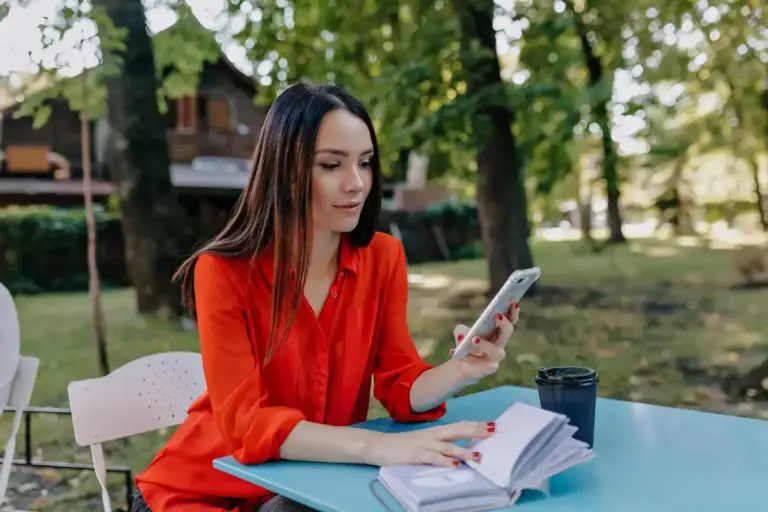 student with smartphone on desk studying netherlands