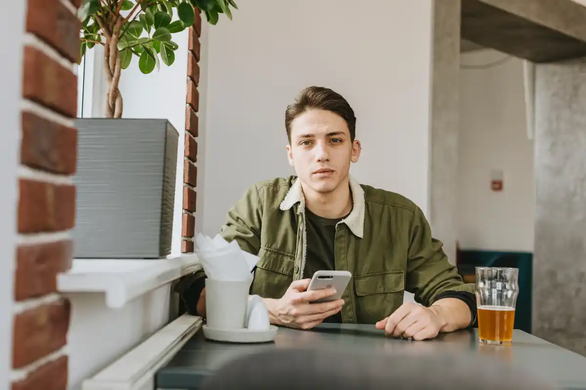 student distracted by phone during studying in cafe netherlands