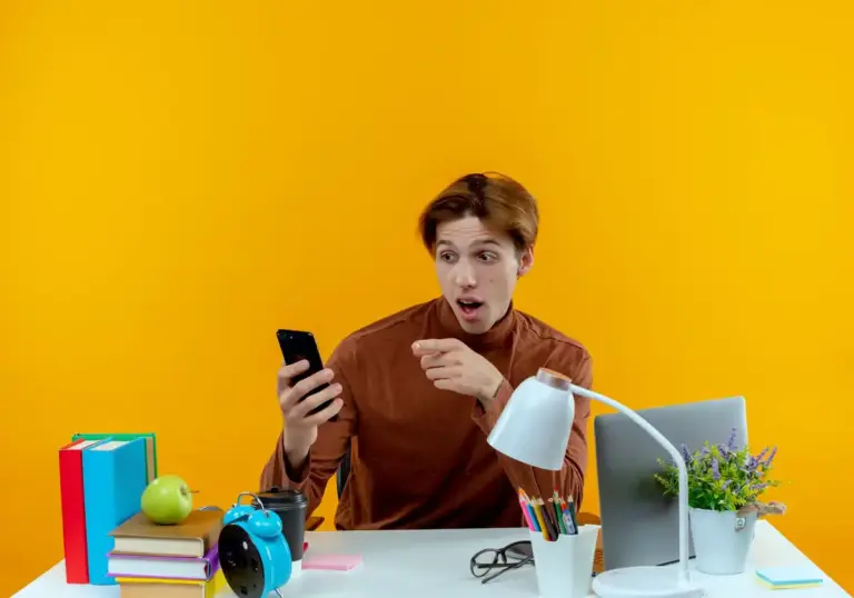 student distracted phone desk Netherlands