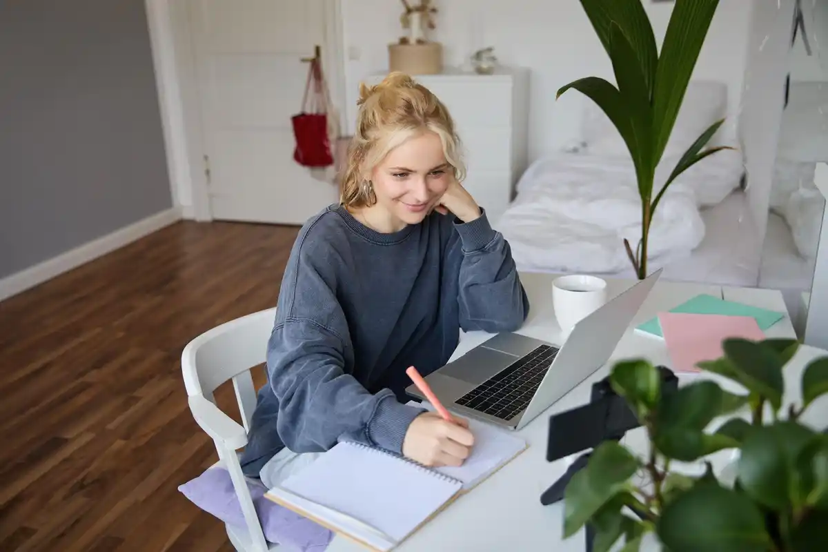 distracted student studying at home with mobile phone