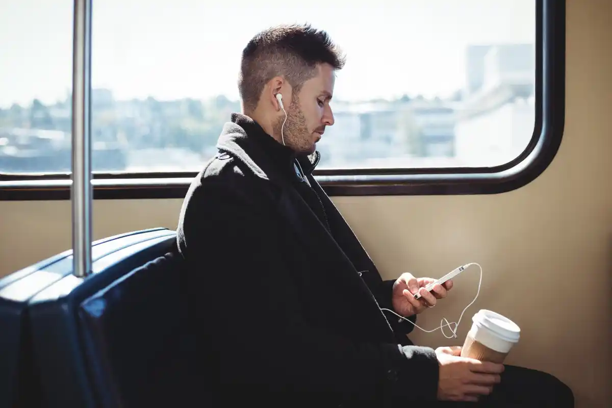 man reading in dutch train window seat morning