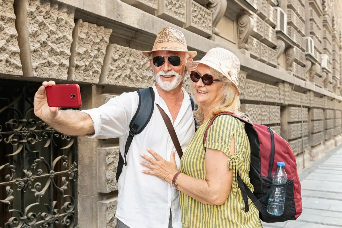senior couple traveling europe smiling city