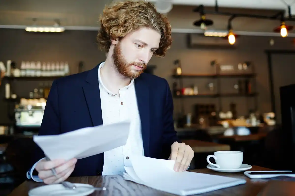 dutch man looking disappointed at bank statement
