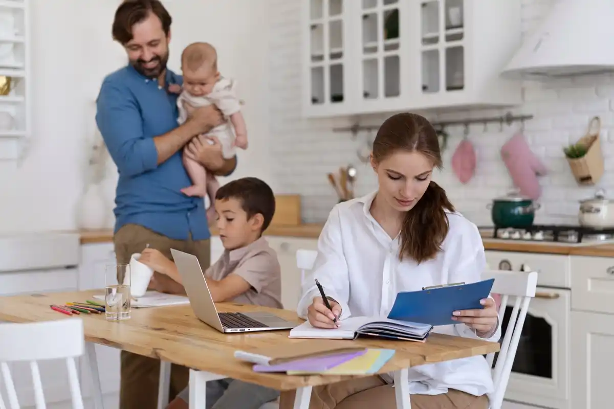 dutch parents calculating baby expenses kitchen table