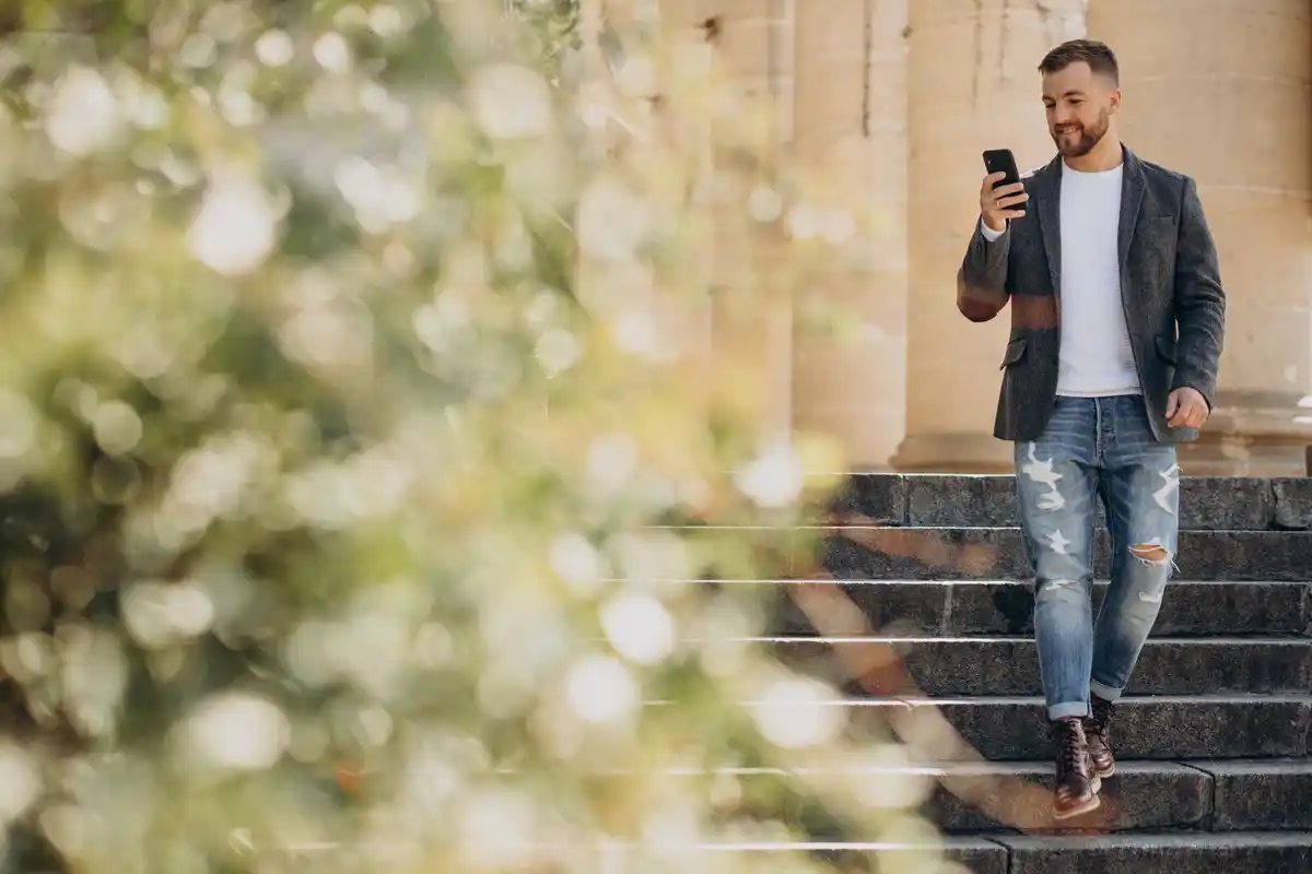 dutch person walking with smartphone outdoors