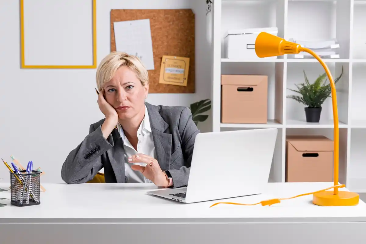 stressed office worker multitasking at desk dutch office