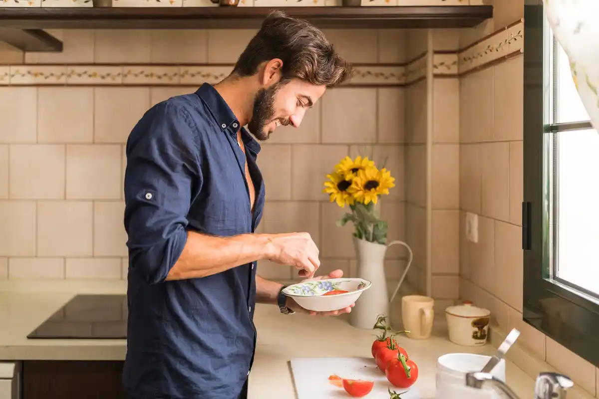 person cleaning kitchen drain eggshells