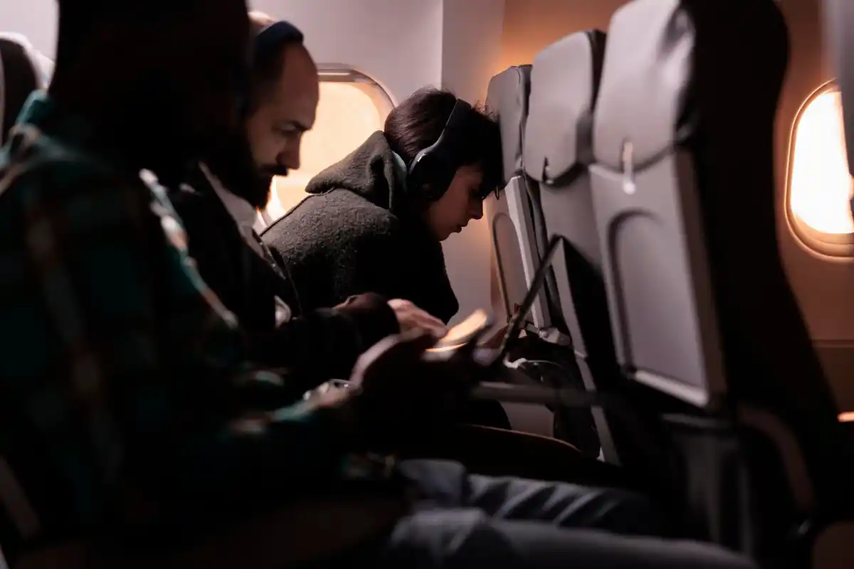 stressed airline passenger breaking flight rules in airplane cabin