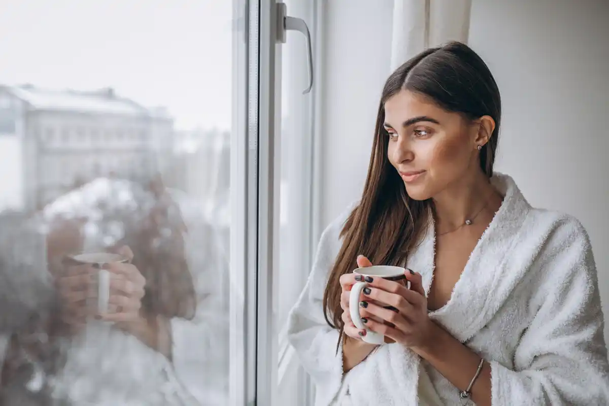 Dutch woman morning skincare sunrise window