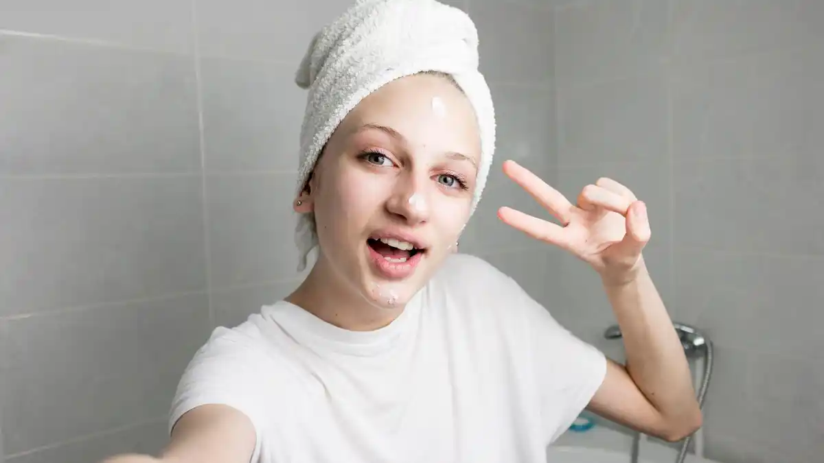 woman applying mayonnaise hair mask at home netherlands