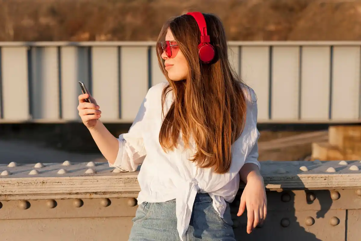 trendy young people using wired earphones in the city