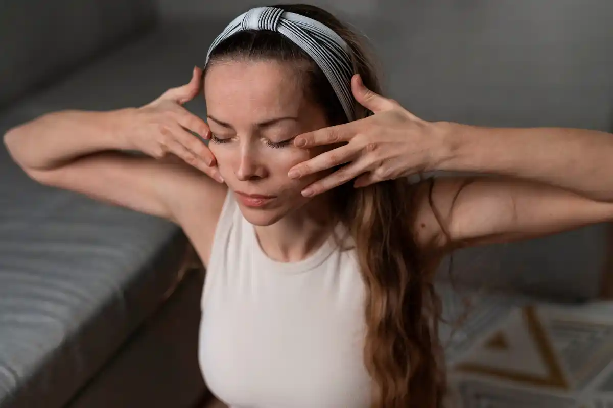 close up woman doing facial massage at home glowing skin korea