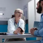 dutch doctor talking with patient, no technology, casual atmosphere