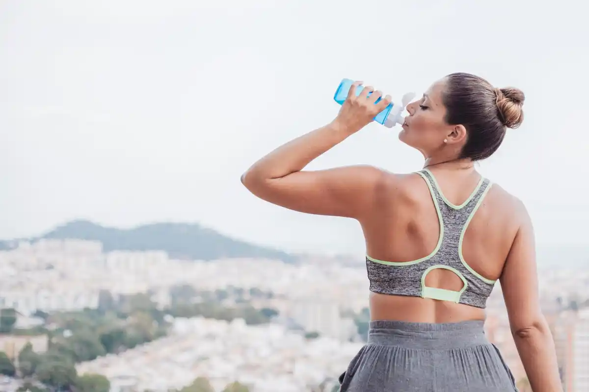 dutch woman drinking cold water after workout