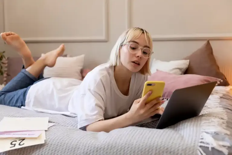 Dutch teens studying with TikTok for exams, smartphone, textbooks, real Dutch room