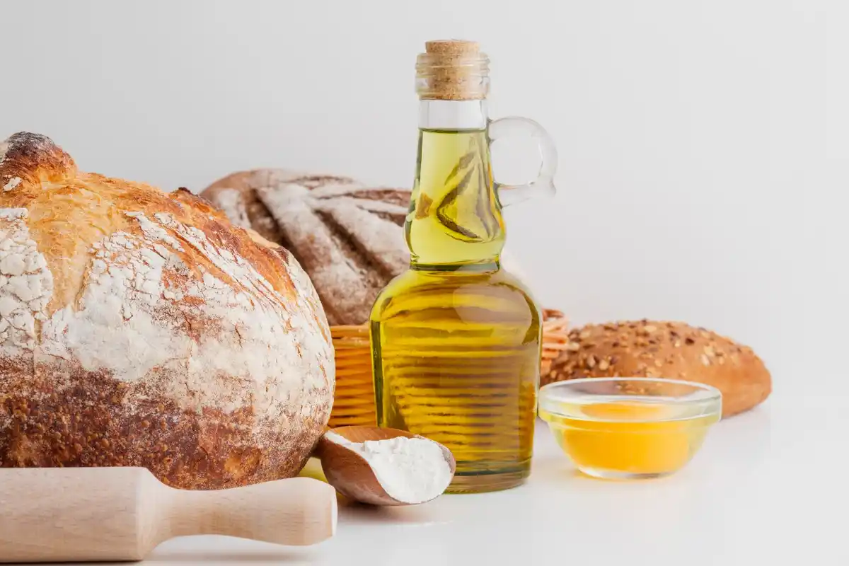 single olive oil bottle with fresh bread and salad Dutch table