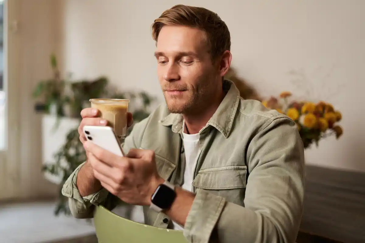 Dutch person checking messages morning phone home