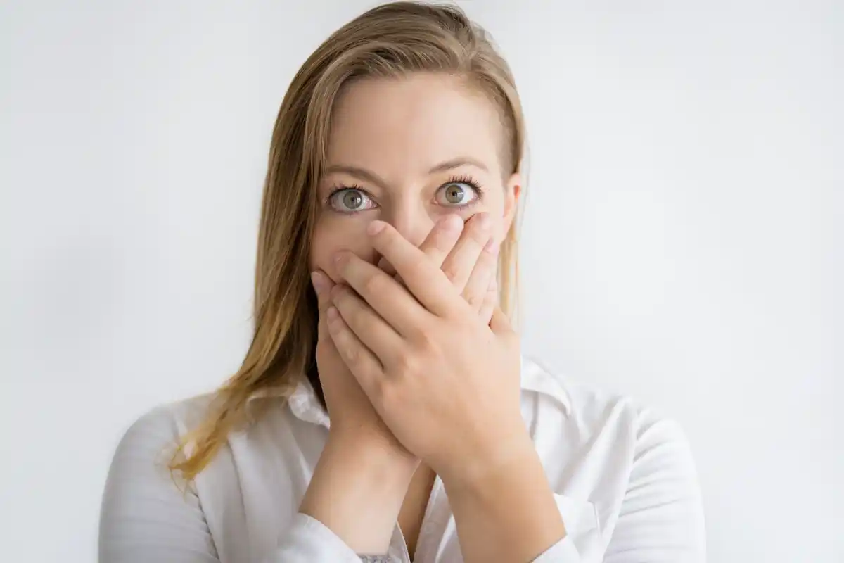 Close-up nervous Dutch woman touching her nose during conversation