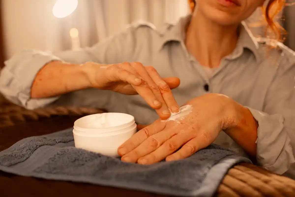 mature woman applying ceramide cream at home Netherlands