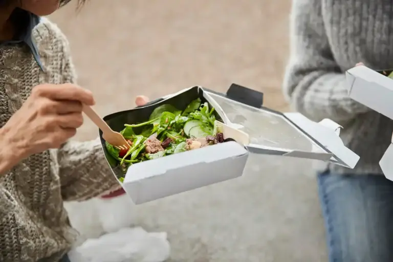 young traveler picking up too good to go surprise food box mediterranean city