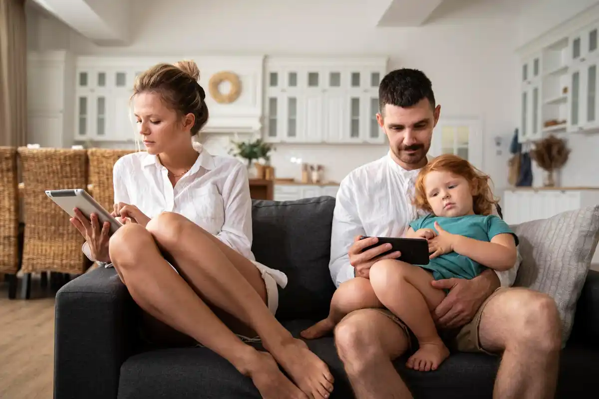 Modern Dutch family checking investment app in living room