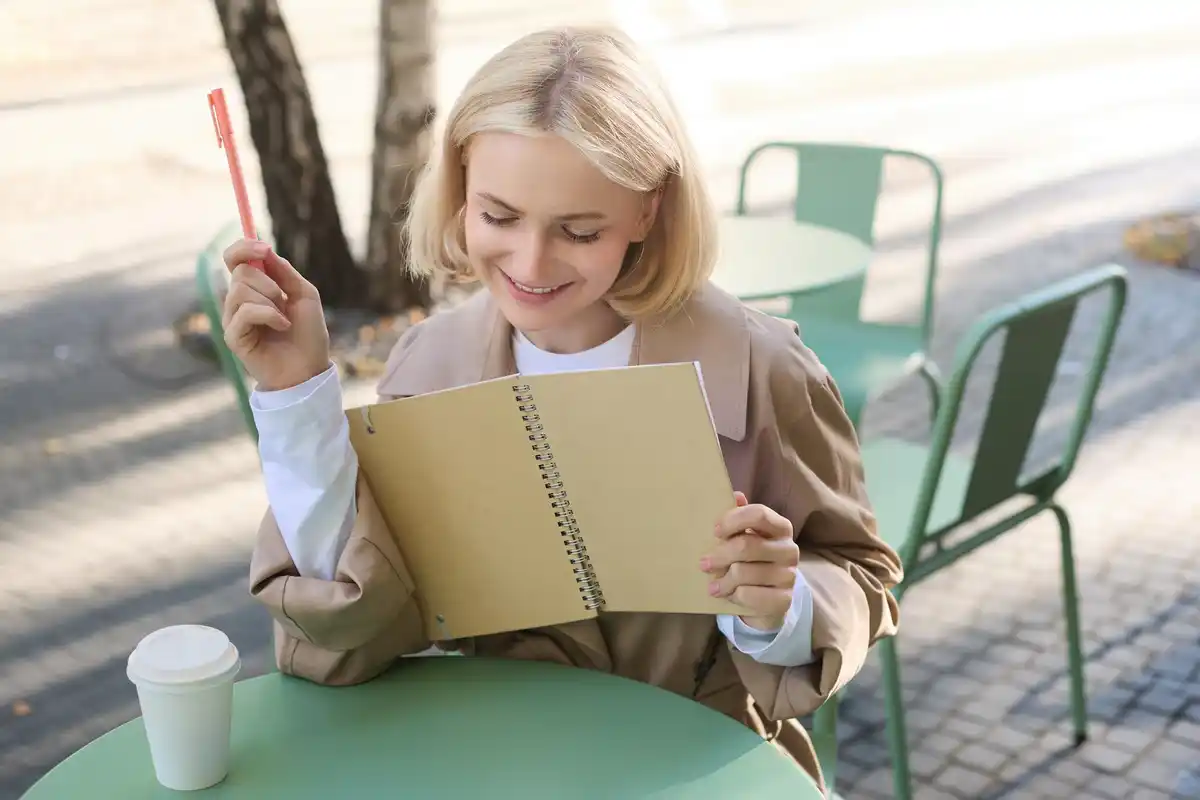 elderly person using a paper planner at a cozy dutch café