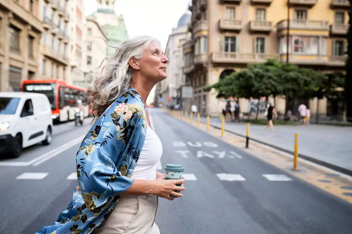 Dutch senior with colorful rain poncho in the city
