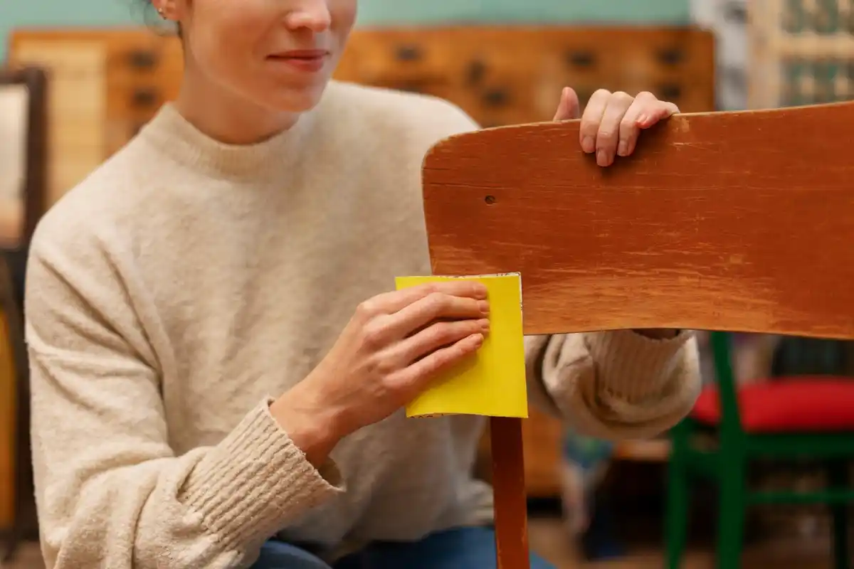close up of hands cleaning wooden furniture with spray cleaner Netherlands