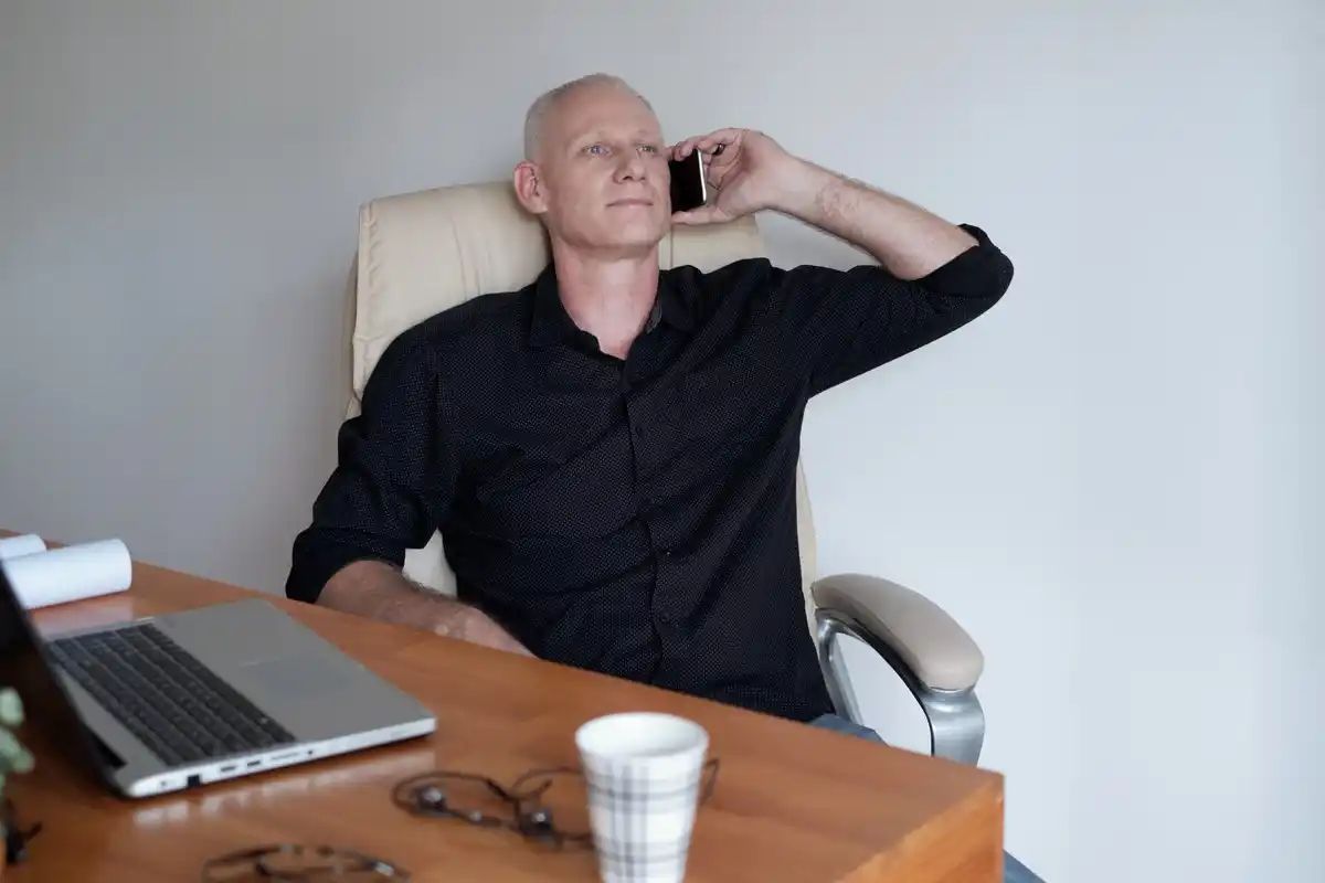 elderly man working efficiently minimalistic desk
