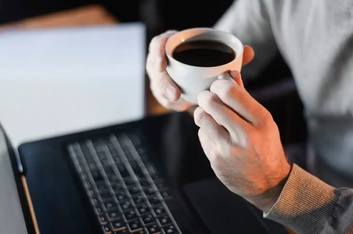 notebook coffee mature hands productivity