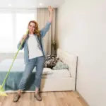 Dutch senior cleaning bedroom dust mites