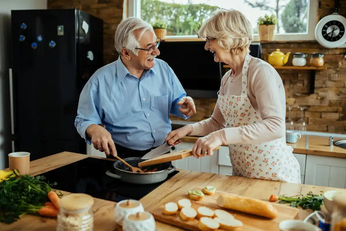 Dutch seniors cooking modern recipes in cozy kitchen