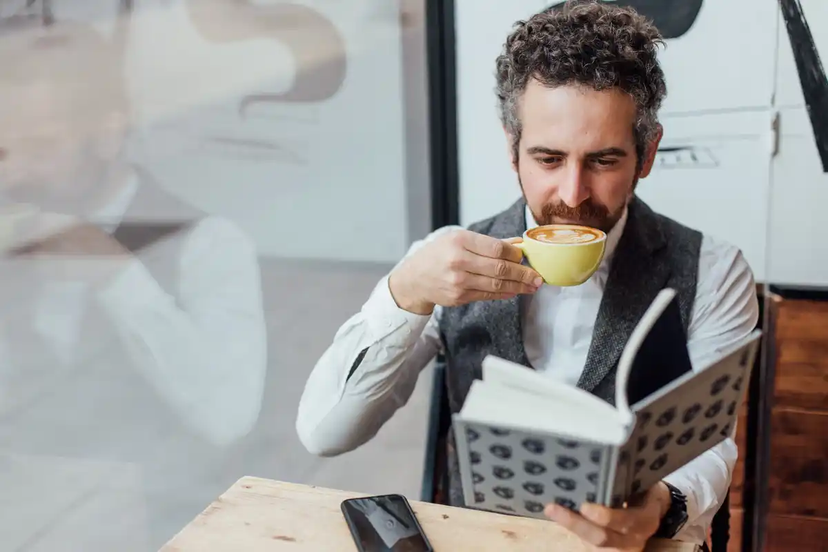 dutch businessman learning with smartphone during coffee break