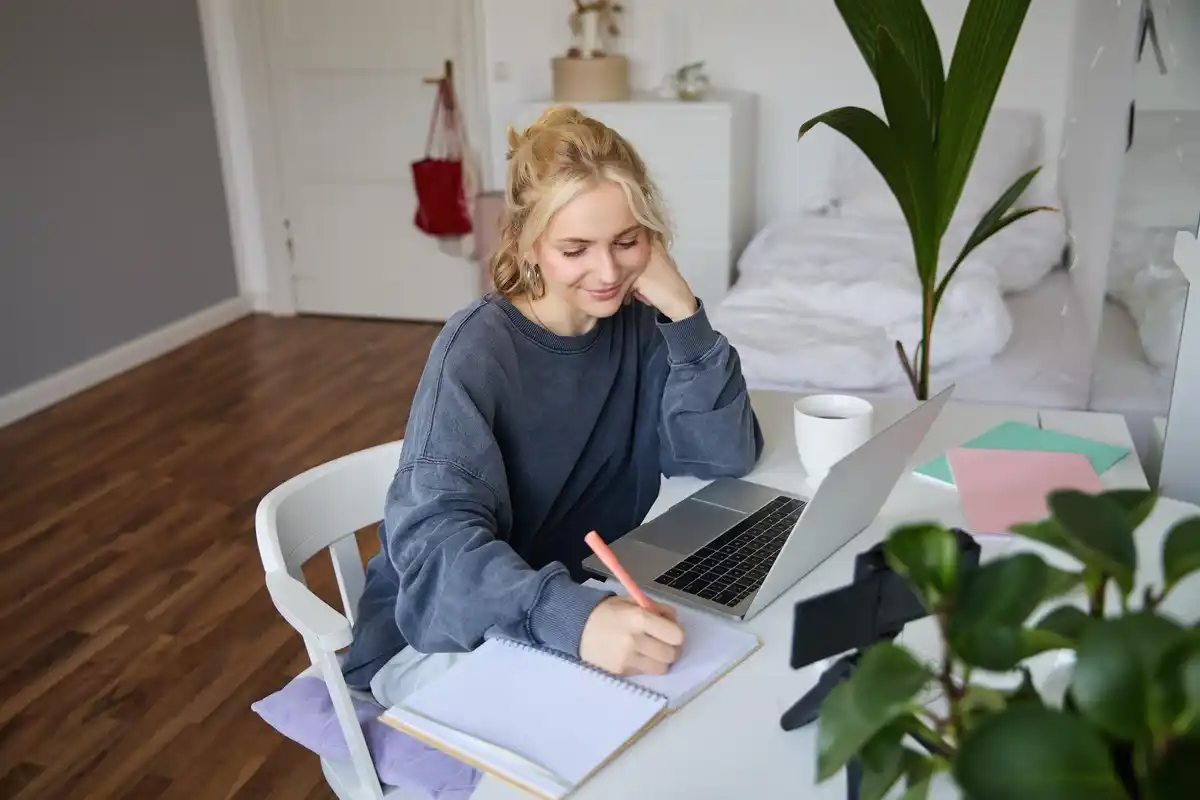 dutch student studying with notes and laptop