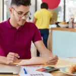 Dutch student making colorful mind map on paper in university setting