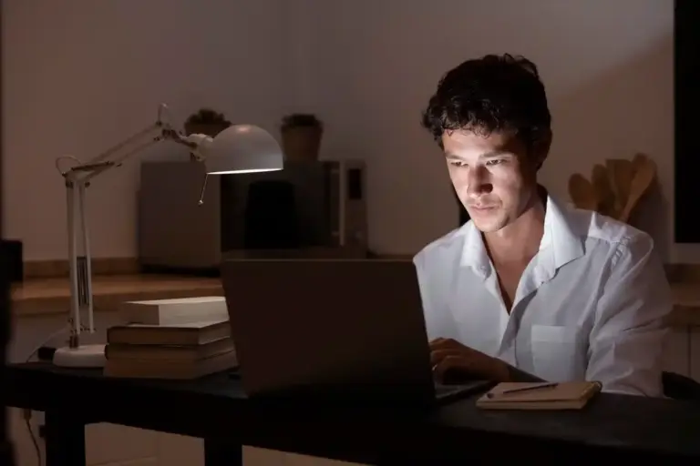 tired Dutch student night study home laptop