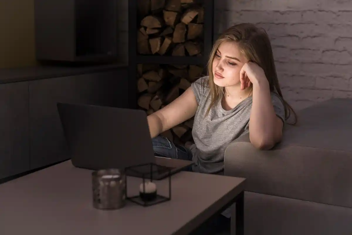 Dutch student studying late night at home, tired, laptop