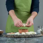 adding ice cube to hot soup bowl Dutch kitchen