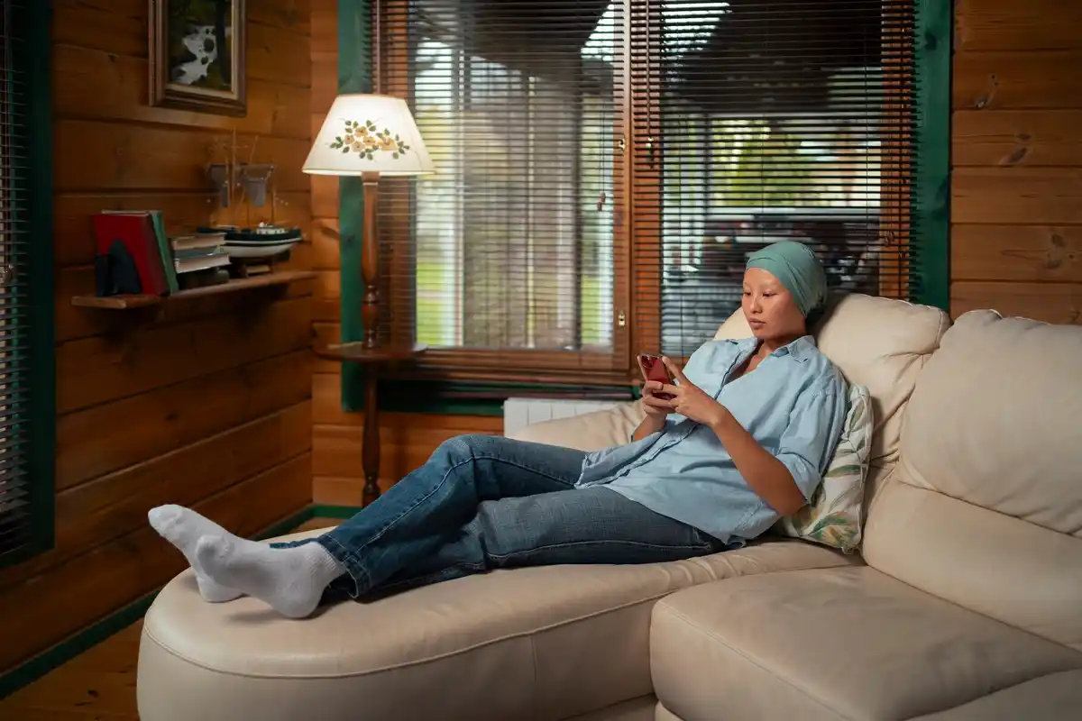 Dutch senior using iPhone in cozy living room
