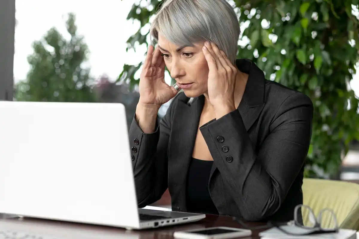 overwhelmed dutch office worker stressed multitasking computer